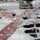 The right side of the vertical stabilizer- the serial number is partly visible- the 4 is marked by the triangular hole, and traces of the 8 and 5 are visible in the flaked-off parts of the red X. the -746 would have continued in the area where the rectangular hole in the skin is now.